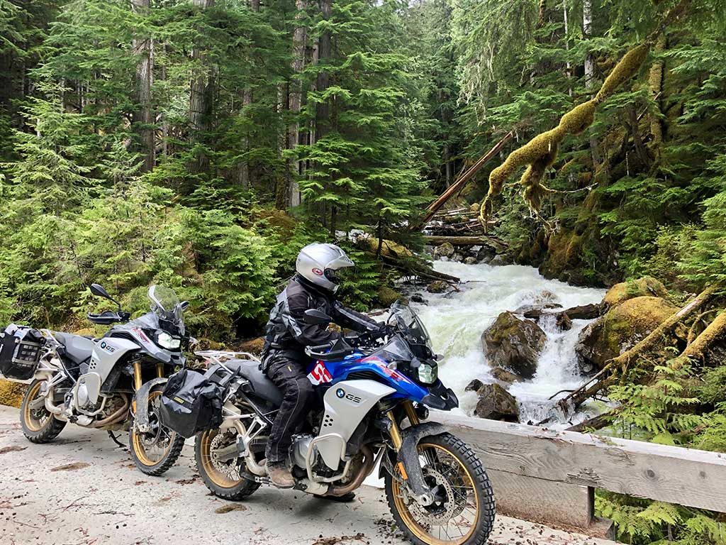 2 bikes parked near a waterfall on a mountain